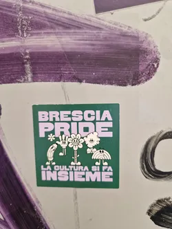 Green sticker with the text Brescia Pride and the phrase La cultura si fa insieme in purple. It features a line of cute cartoon characters.