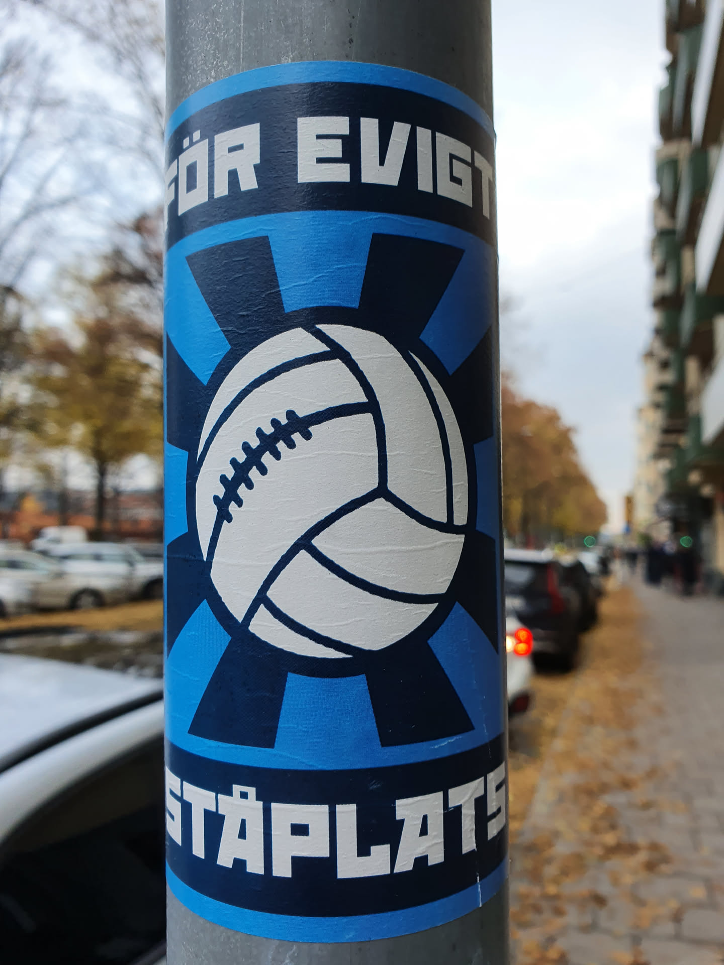 A blue and white sticker featuring a stylized soccer ball with the text "FÖR EVIGT" at the top and "STÅPLATS" at the bottom. The sticker has a retro design with radiating lines behind the ball.