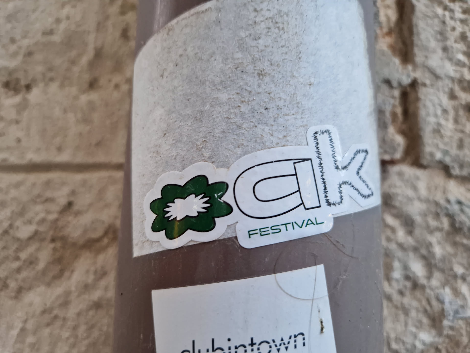 A sticker featuring the stylized letters "CK" with a small green flower-like design next to it. The words "FESTIVAL" are written under the letters.