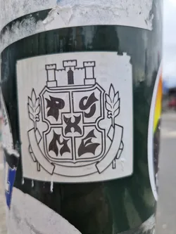 A square sticker featuring a black and white illustration of a coat of arms. The design includes a castle, stylized symbols, and plant motifs.  The style is simple and graphic.