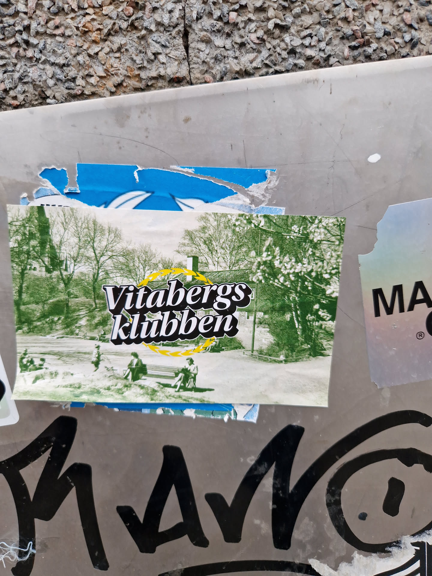 A sticker featuring a nostalgic image of Vitabergsklubben. The sticker has a slightly worn look, adding to its charm. The text 'Vitabergsklubben' is prominently displayed in a stylized font.