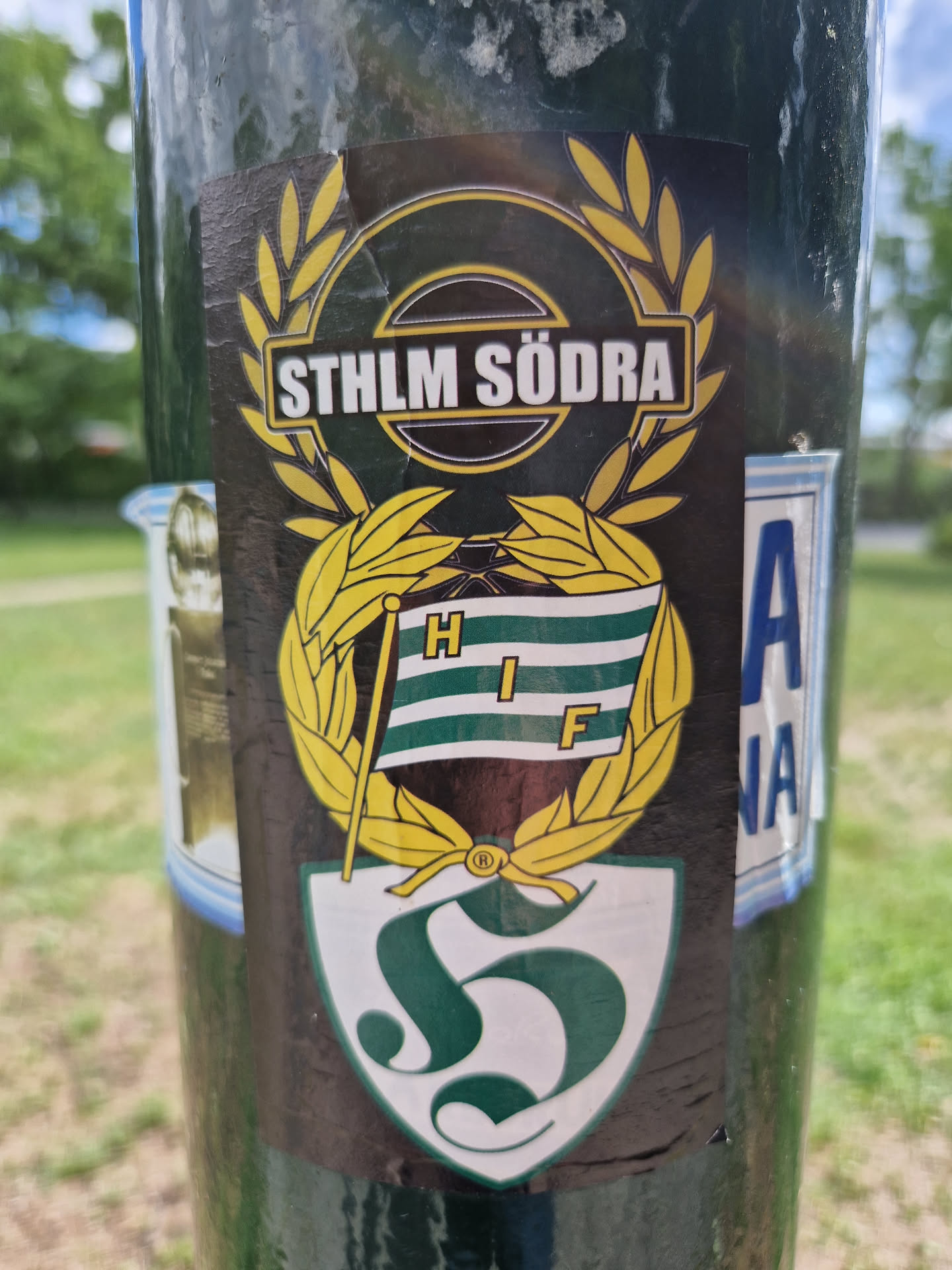 A sticker featuring the logo of STHLM SÖDRA, which seems to be a supporters' club or related to Hammarby IF (HIF). The design includes a crest with the letter 'S' and laurel wreaths.