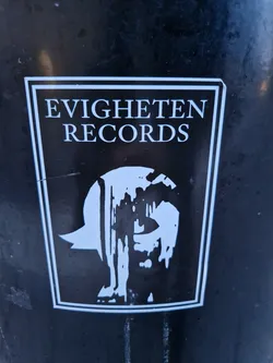 Black and white sticker with the text "EVIGHETEN RECORDS" and a graphic design of a face with dripping paint. The sticker has a rectangular shape with a white border.