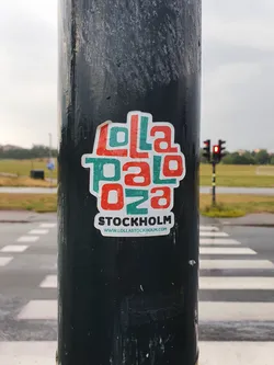 A sticker featuring the Lollapalooza Stockholm logo.  The text on the sticker says "Lollapalooza" in a stylized font with the numbers "028" below it, and "STOCKHOLM" below that.  A website address is printed below the text: www.lollastockholm.com