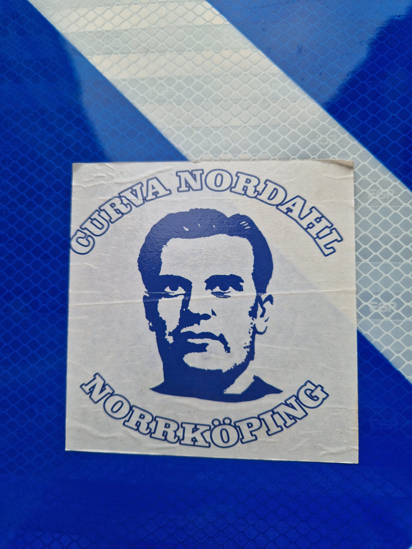 A blue and white sticker featuring a portrait of Nordahl and text that says Curva Nordahl Norrköping.