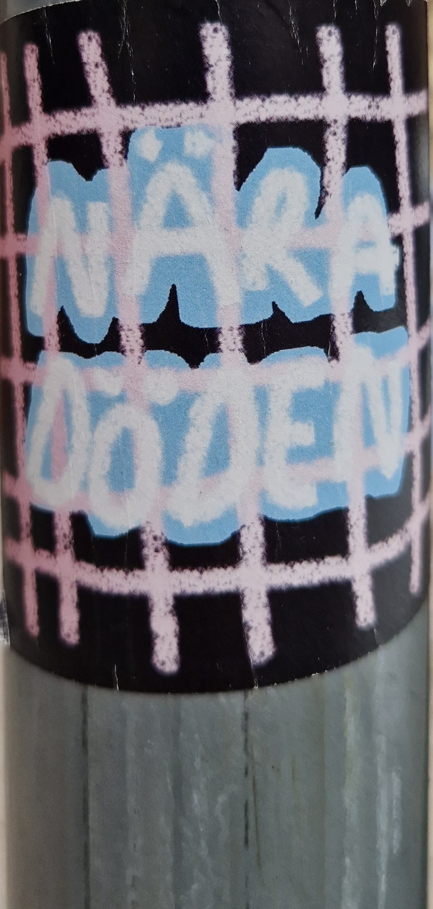 A sticker featuring the text "Nara Dvolen" in light blue and pink lettering on a black background with a pink grid pattern. The text appears to be stylized graffiti or hand-painted.