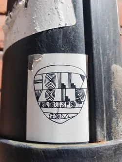 A black and white sticker with an abstract design incorporating geometric shapes and patterns.  The text 'blogspot.com' is visible within the design.