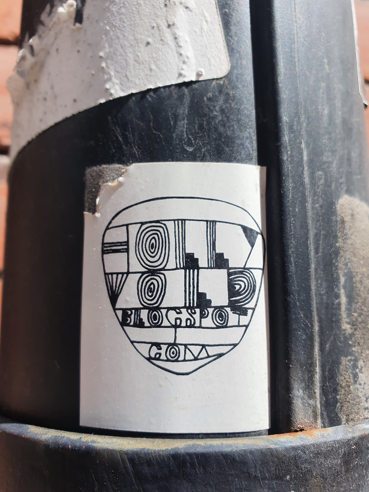 A black and white sticker with an abstract design incorporating geometric shapes and patterns.  The text 'blogspot.com' is visible within the design.