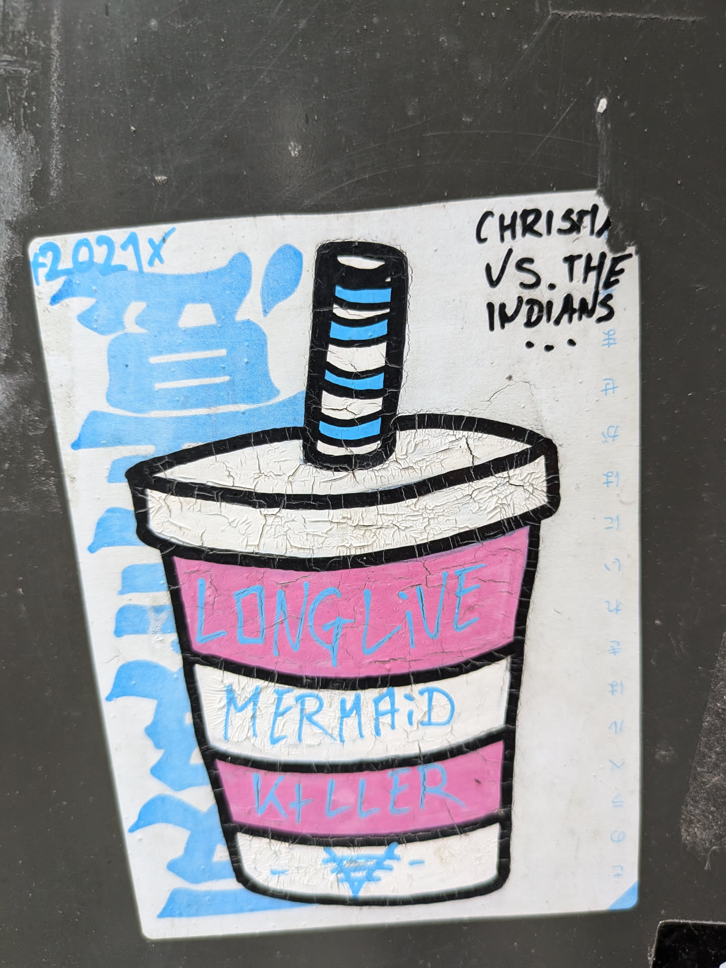 A sticker featuring a stylized illustration of a cup with the text "Long Live Mermaid Killer" on it.  There's also some additional text that seems to be a signature or artist tag including the words "CHRISTINA VS THE INDIANS". The sticker has a slightly distressed or cracked appearance, adding to its aesthetic.