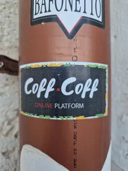 A sticker with the text "Coff Coff" and the words "Online Platform" underneath. The sticker has a black background with yellow and green accents.