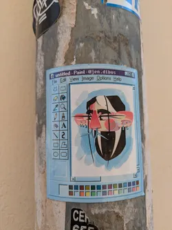 A light blue sticker featuring an abstract face is adhered to a pole. The image is designed to resemble the classic Windows Paint application interface. The 'untitled - Paint - @jen.dibus' title bar is visible at the top. The abstract face is stylized with angular shapes and lines.