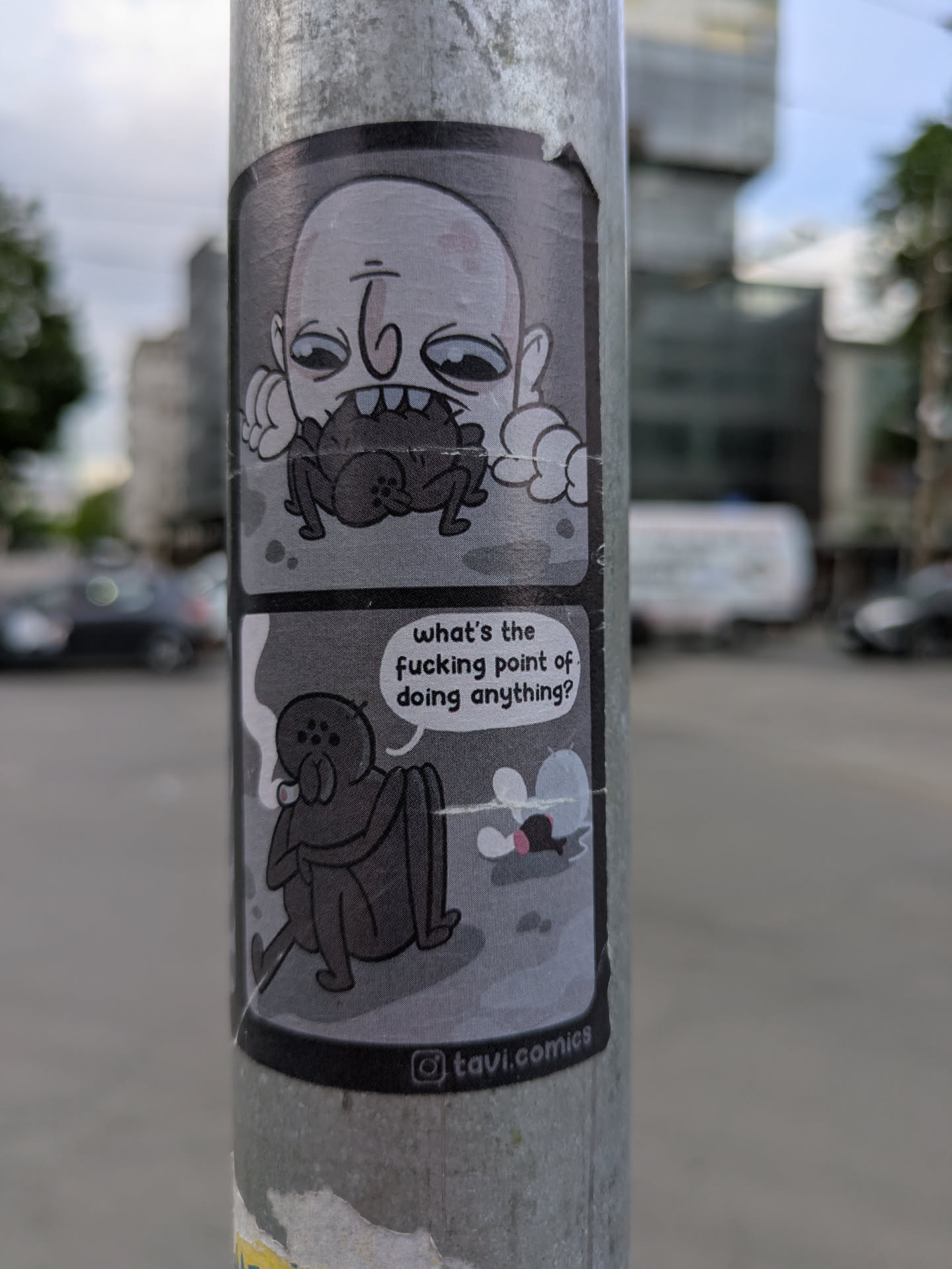 The sticker depicts a two-panel comic. In the first panel, a grotesque character is eating a spider. In the second, another spider sits smoking, pondering, "What's the fucking point of doing anything?" The sticker includes the Instagram handle @tavi.comics.