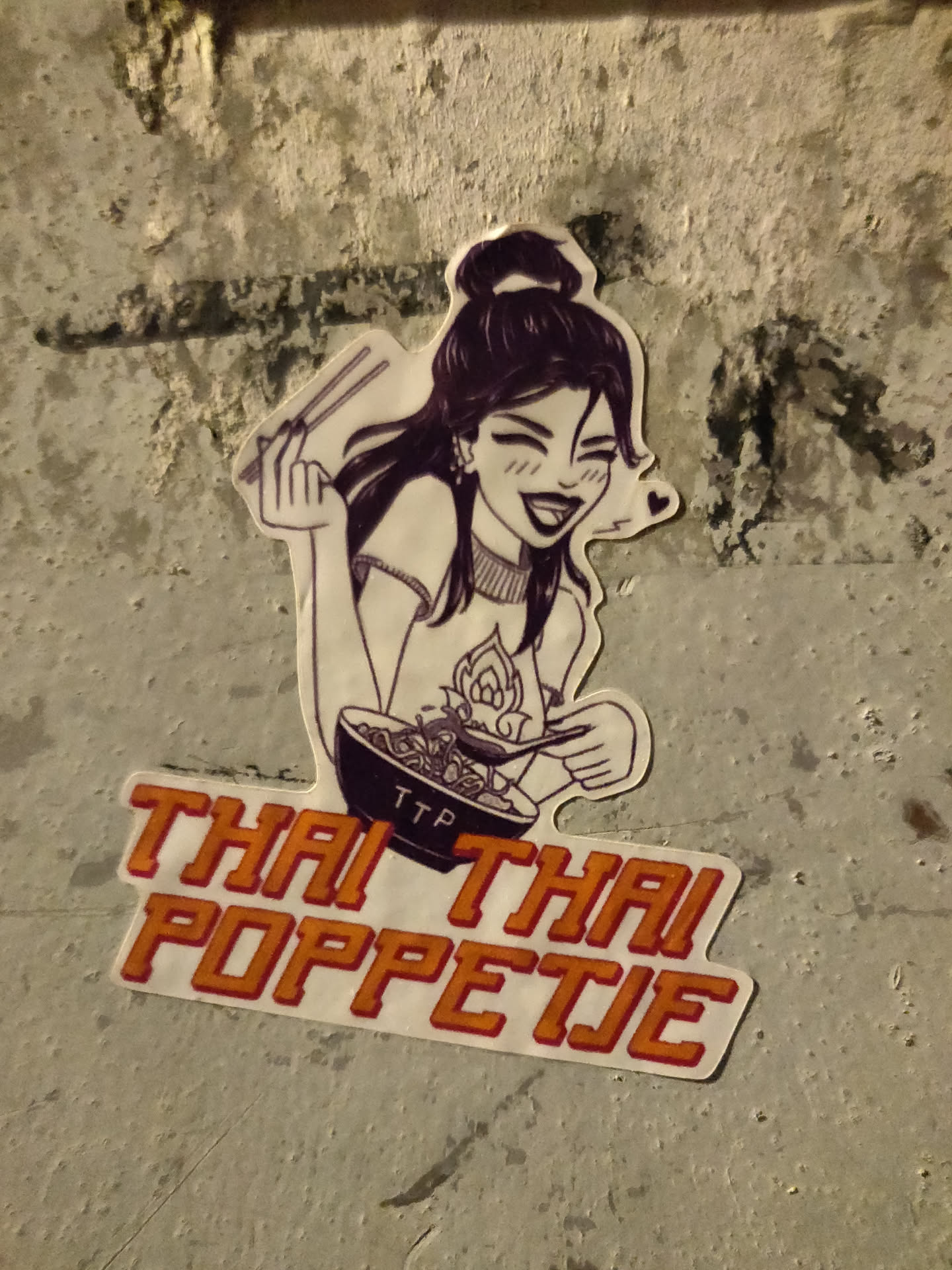 Sticker featuring an illustration of a girl enjoying a bowl of noodles. The text 'Thai Thai Poppetie' is prominently displayed below the illustration.