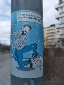 This sticker shows a light-hearted cartoon illustration of a man with full body tattoos dancing exuberantly. He seems to be celebrating a victory indicated by the Swedish text. The style is reminiscent of a comic strip or graphic novel.