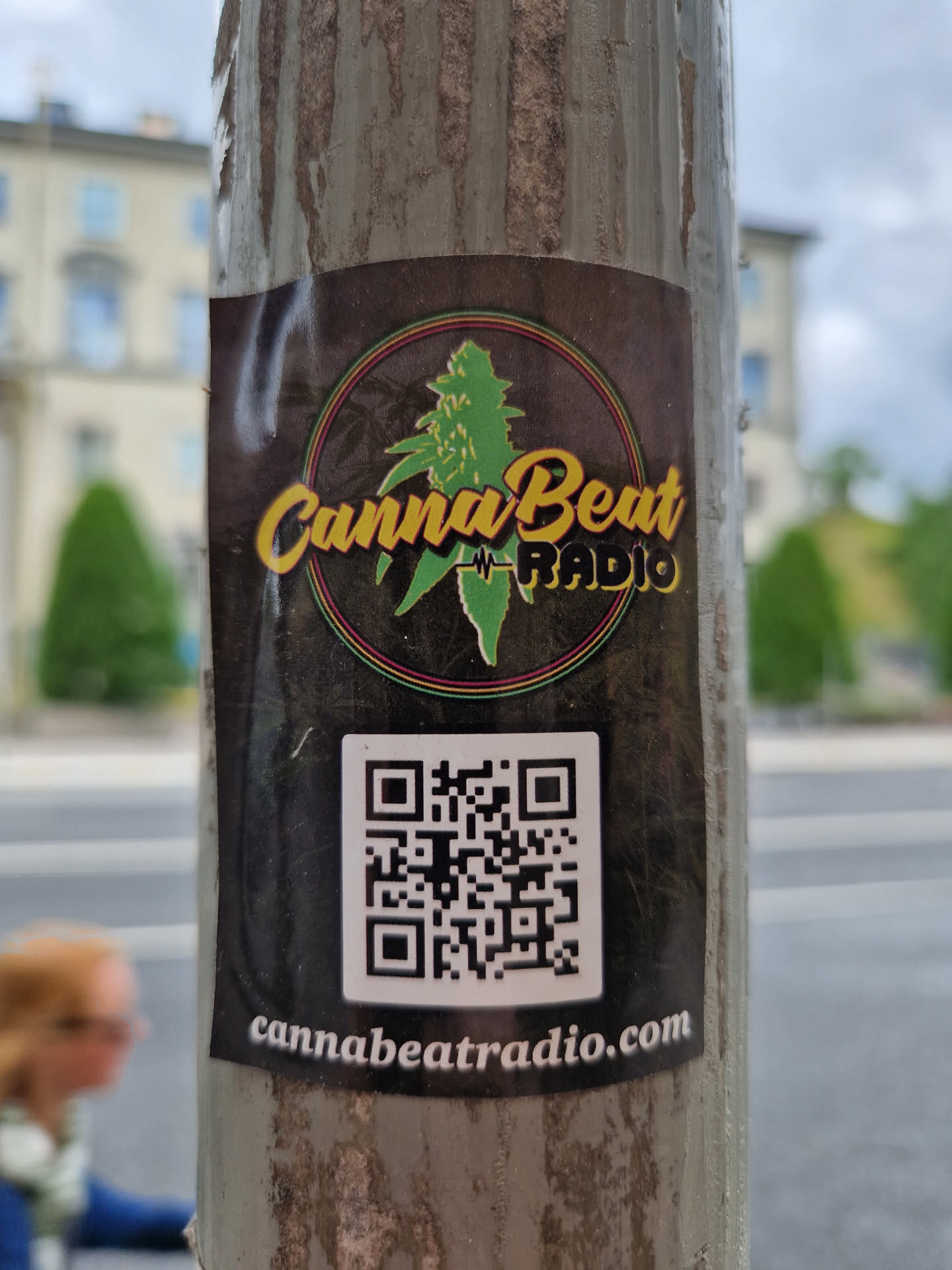 A sticker for CannaBeat Radio. The sticker has a dark background with a logo of a cannabis leaf and the text 'CannaBeat Radio'. It also contains a QR code that leads to cannabeatradio.com.