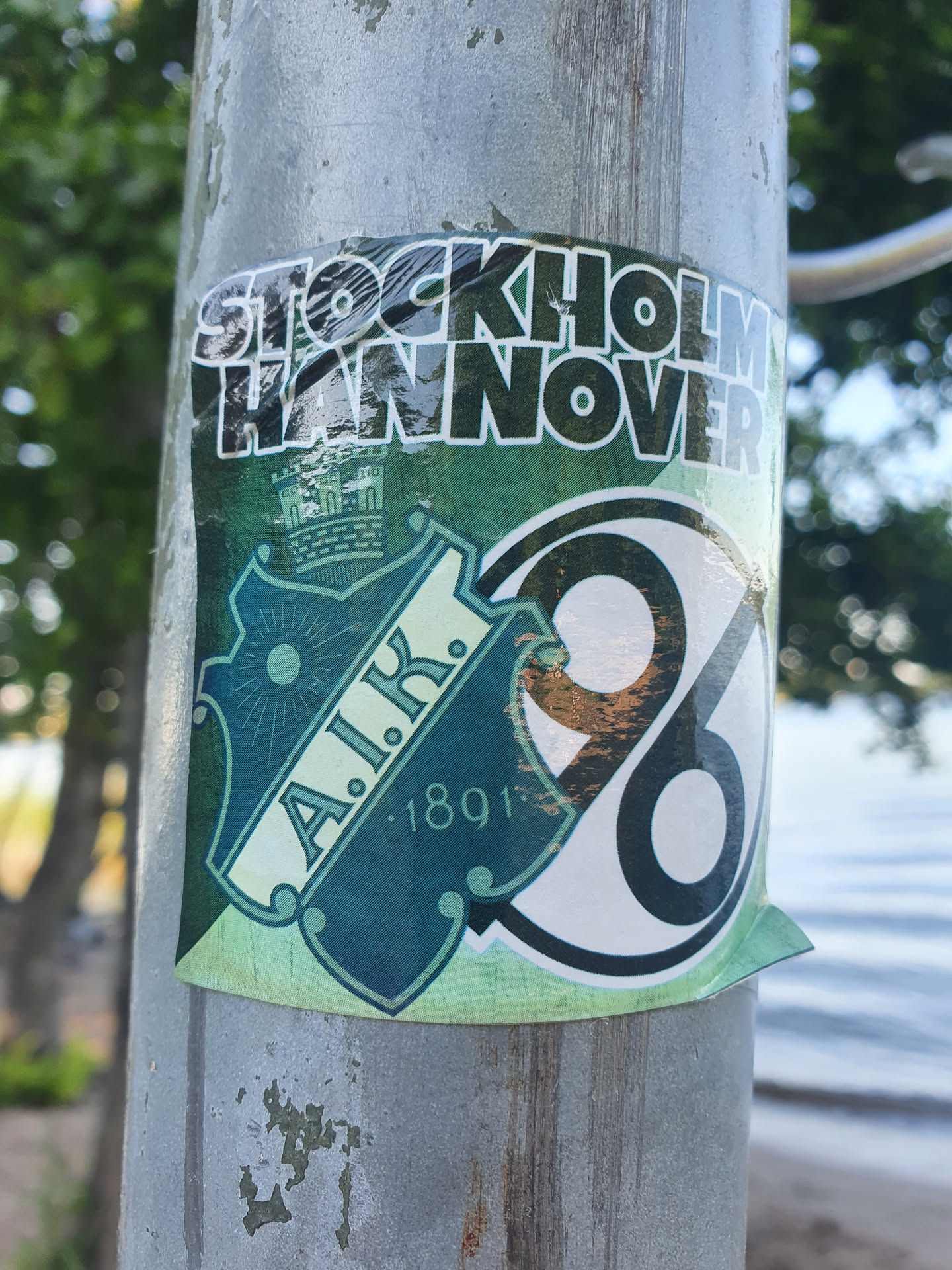 A sticker featuring the text 'STOCKHOLM HANNOVER' at the top, and a logo with 'A.I.K. 1891' in the center. The logo includes a crest and a number '98'.