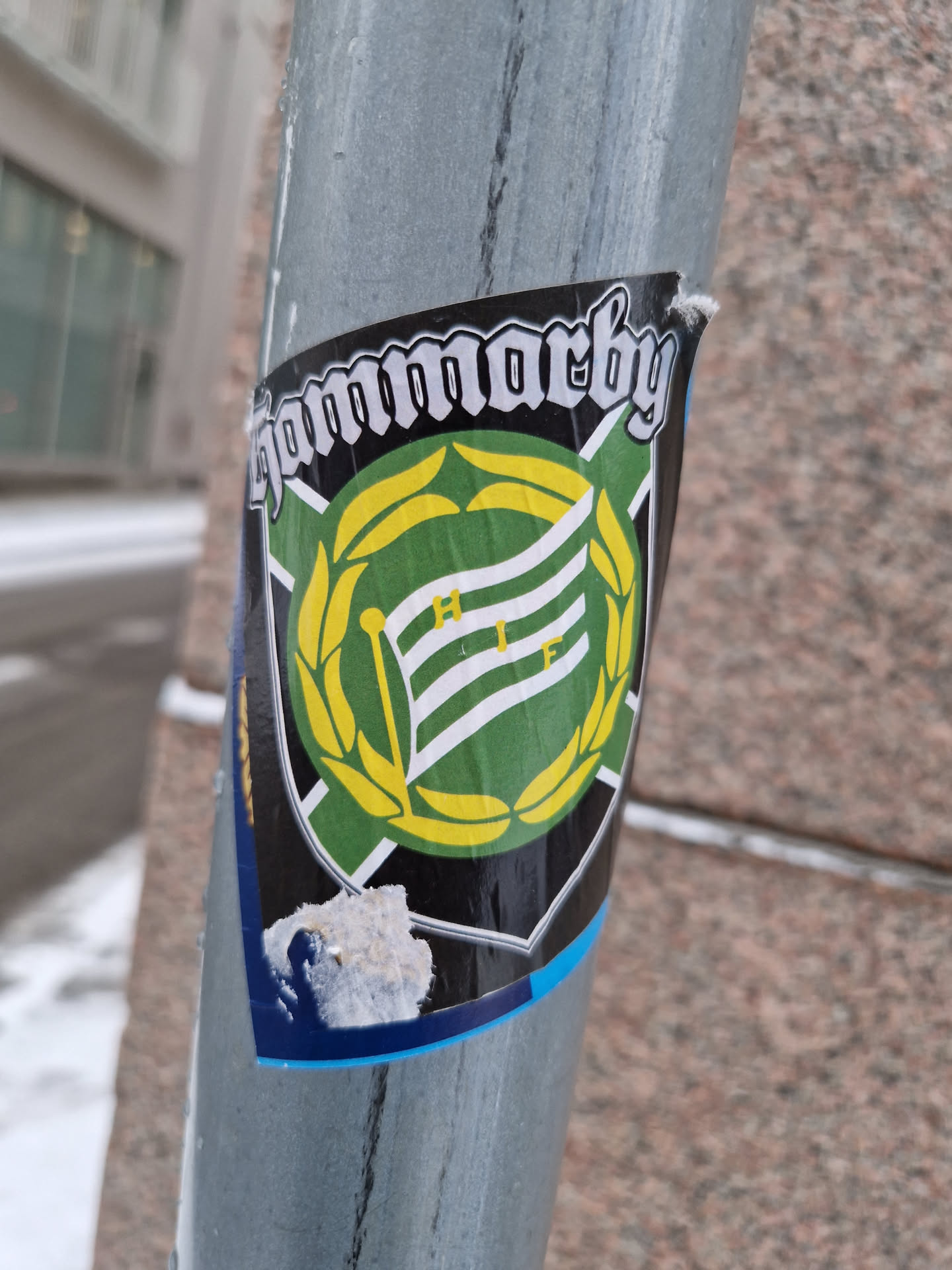 A sticker featuring the logo of Hammarby IF, a Swedish football club. The logo is a green and yellow crest with a flag and laurel wreath.  The text "Hammarby" is written above the crest in a gothic-style font.