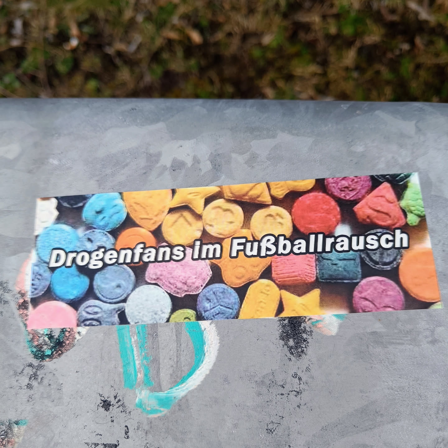 A sticker depicting colorful pills with the text "Drogenfans im Fußballrausch" which translates to "Drug fans in football frenzy".  The image is a strong warning against drug use, especially within the context of football (soccer).
