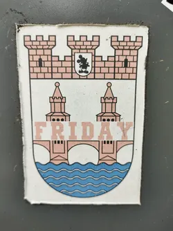 A sticker featuring a coat of arms design with a bridge and the word "FRIDAY" across the middle. The style is simple and playful. 