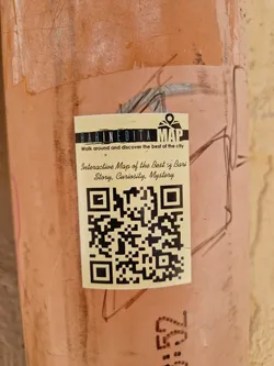 A sticker promoting an interactive map of Bari, Italy.  The map promises stories, curiosity, and mystery.  A QR code is included for easy access.