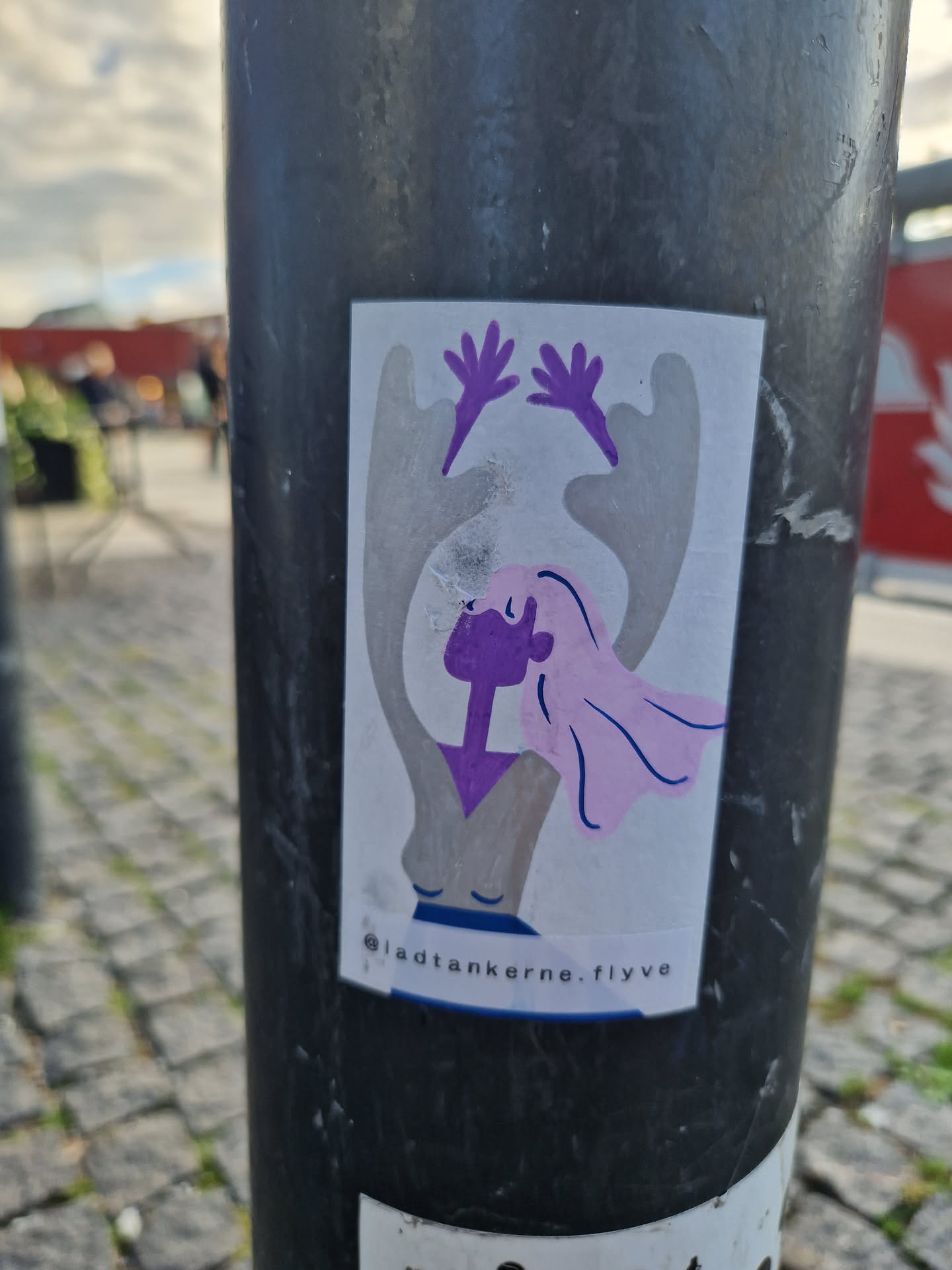 Purple and pink illustration of a stylized female figure with arms raised, hair blowing in the wind. The sticker features the Instagram handle @ladtankerne.flyve at the bottom.