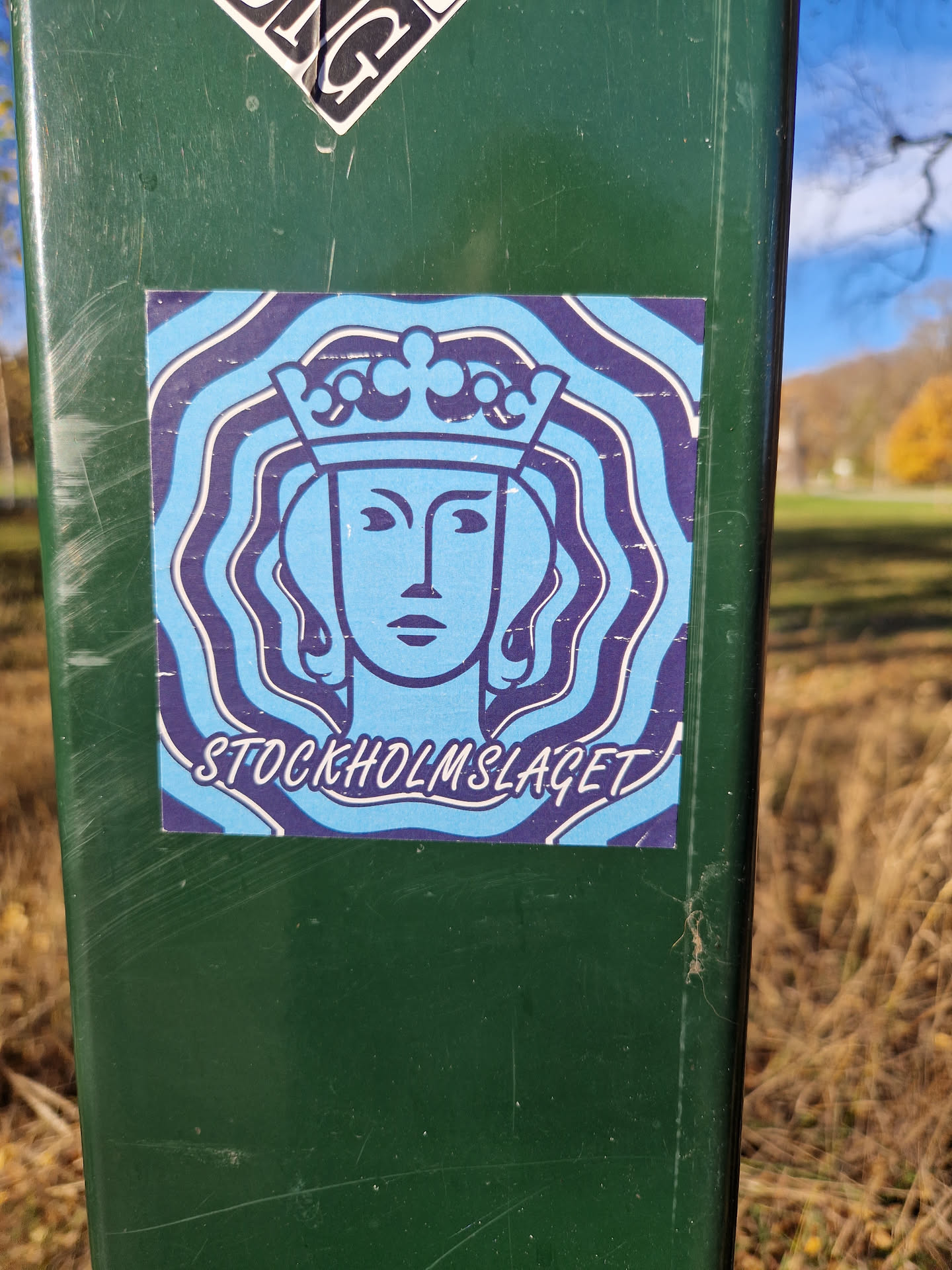 A sticker featuring a stylized illustration of a queen wearing a crown, set against a swirling, psychedelic background. The text 'STOCKHOLMSLAGET' is visible at the bottom.