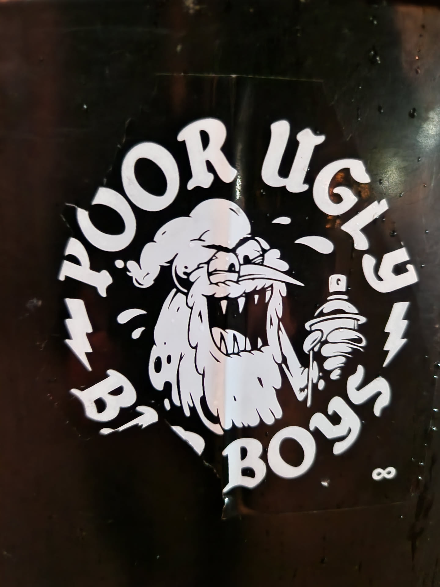 Black and white sticker with an illustration of a monster holding a spray can. The text "Poor Ugly Boys" is written around the illustration.