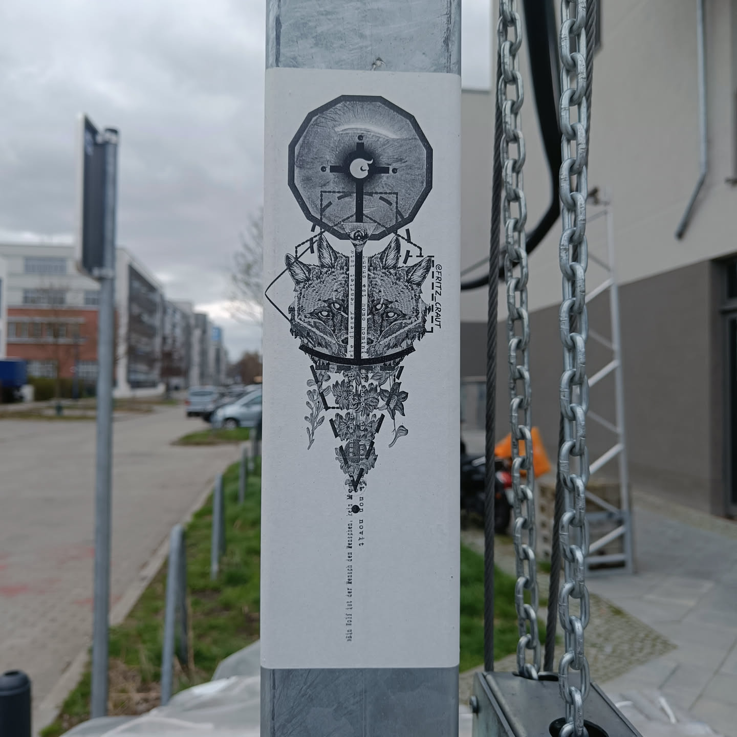 A grayscale sticker featuring a stylized fox's face, geometric shapes, and symbolic imagery. The design is detailed and intricate, with elements suggesting a balance between nature and geometry.  The text at the bottom appears to be German.