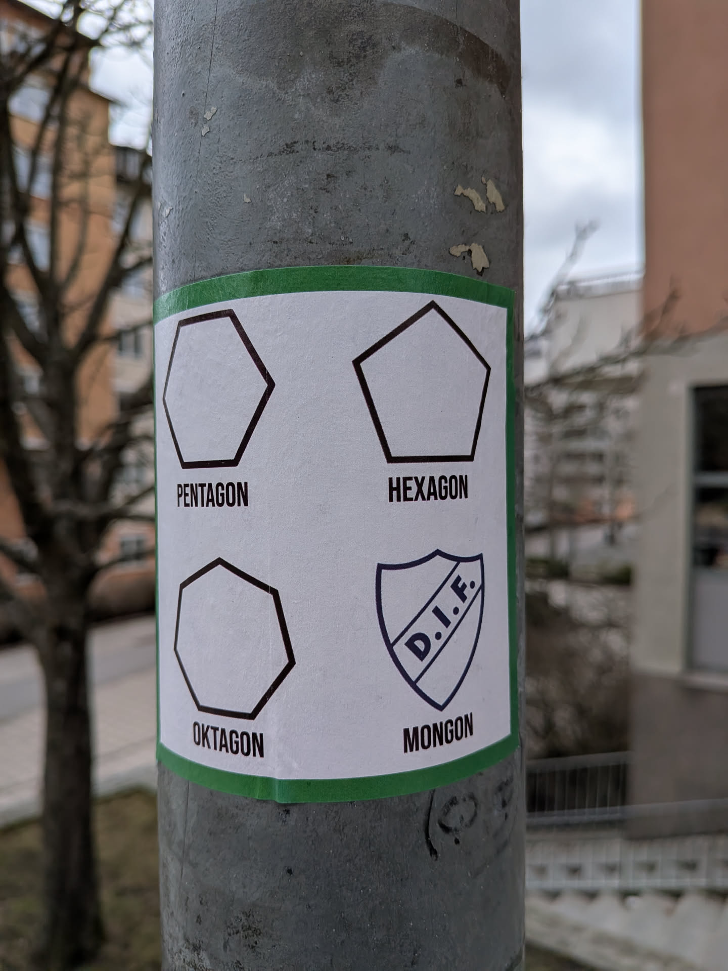 A rectangular white sticker with a thin green border, affixed to a grey, textured metal pole. The sticker is divided into four quadrants, each featuring a black outline of a geometric shape or a logo, with a corresponding word in black text below it. The top-left shows a pentagon outline with 'PENTAGON'. The top-right shows a hexagon outline with 'HEXAGON'. The bottom-left shows an octagon outline with 'OKTAGON'. The bottom-right features a shield-shaped logo with the letters 'D.I.F.' inside, and the word 'MONGON' below it. The sticker appears slightly worn and adhered to the pole.