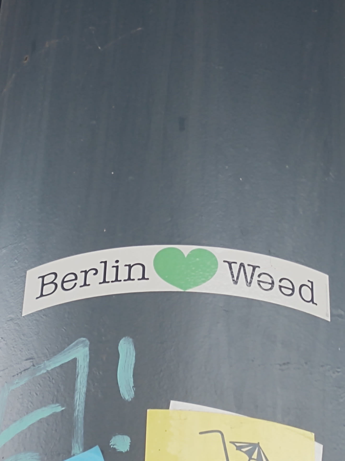 A sticker expressing love for weed in Berlin.  The sticker features the words 'Berlin' and 'Weed' with a green heart symbol in between.