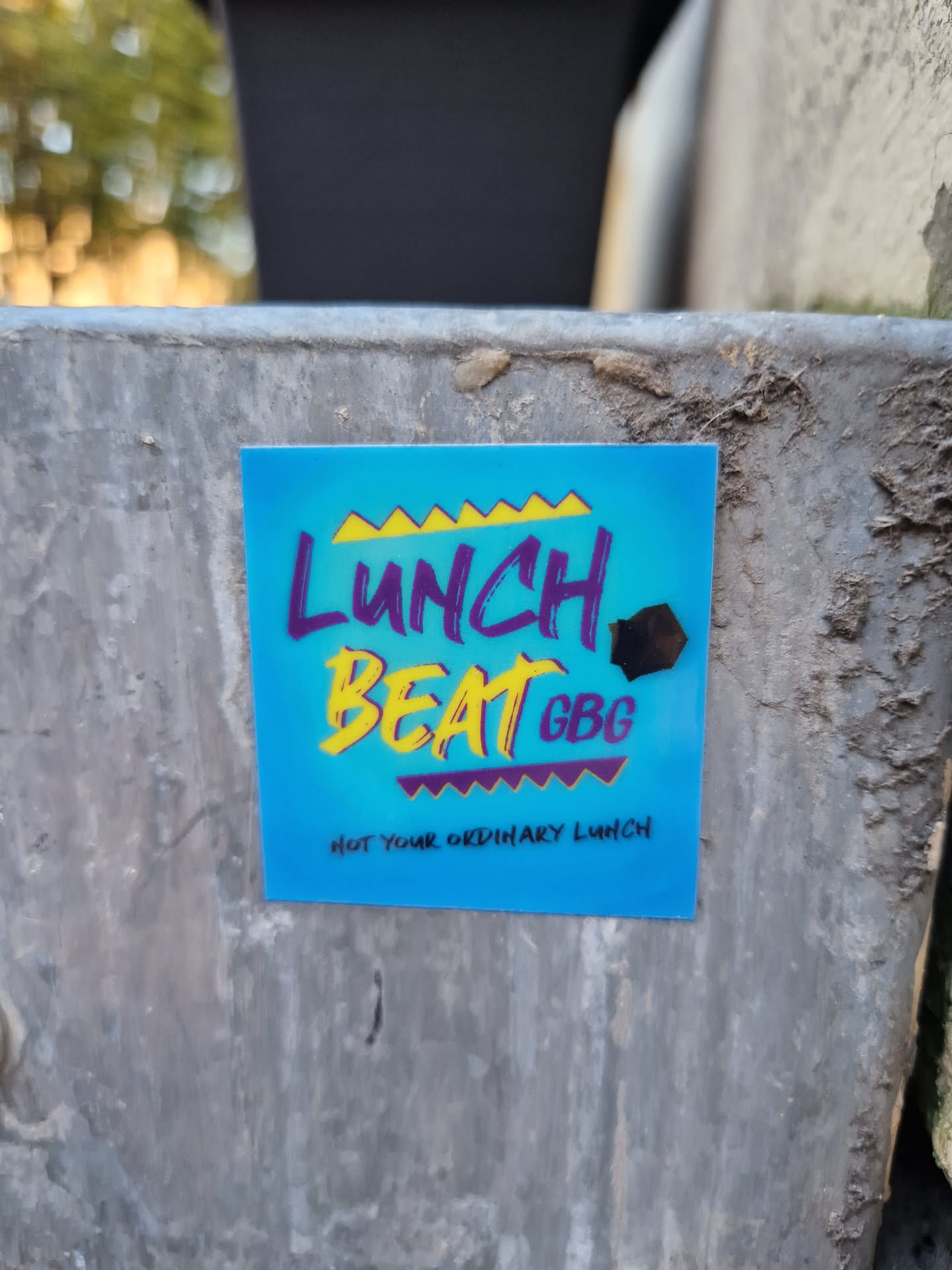 A blue sticker with the text "Lunch Beat GBG" in yellow and purple stylized lettering.  Below it, in smaller text, it says "Not your ordinary lunch".
