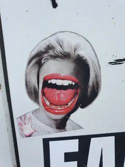 This sticker features a collage-style image of a woman with an oversized mouth and bright red lips. Her expression is one of a loud shout or scream. The style is reminiscent of vintage or pop art, with a surreal twist. The image is striking and thought-provoking, with a blend of retro aesthetics and a modern twist.