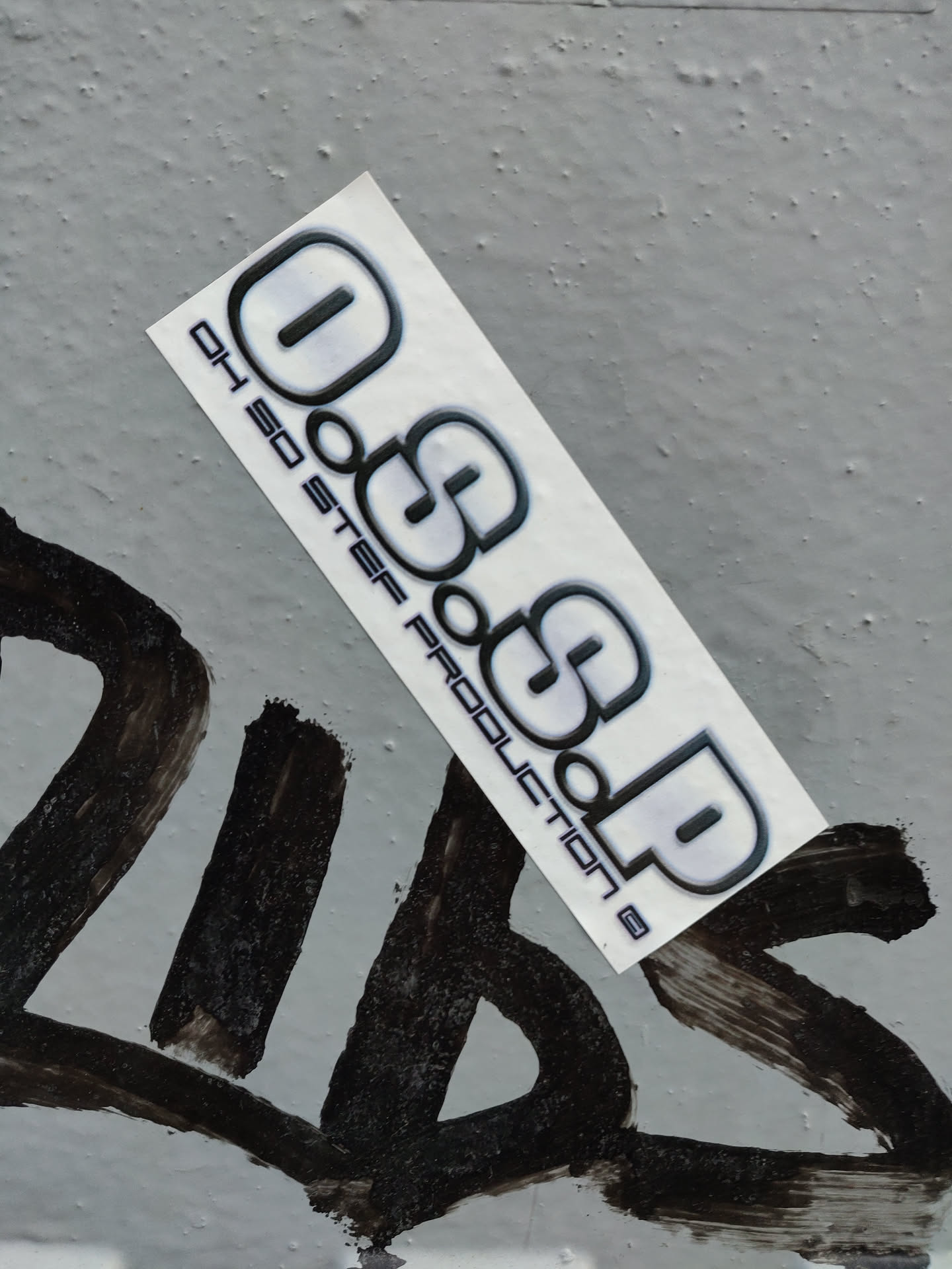 A sleek, gray and black sticker featuring the logo "OGSOP" with the text "01 SO STEP Production" underneath.  The sticker has a modern, minimalist design.
