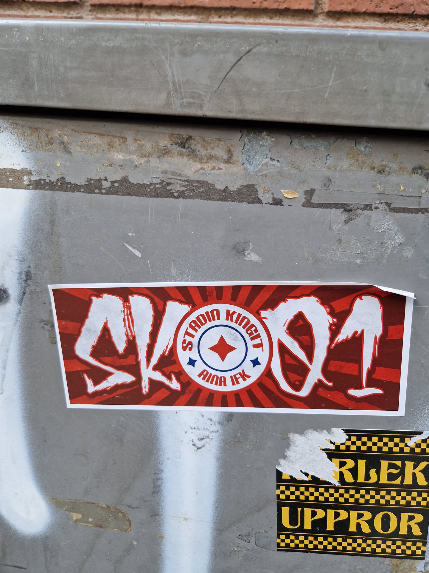 Red and white sticker with stylized text SK91 and a logo that says "Stadium Kings" and "AIK IFK".
