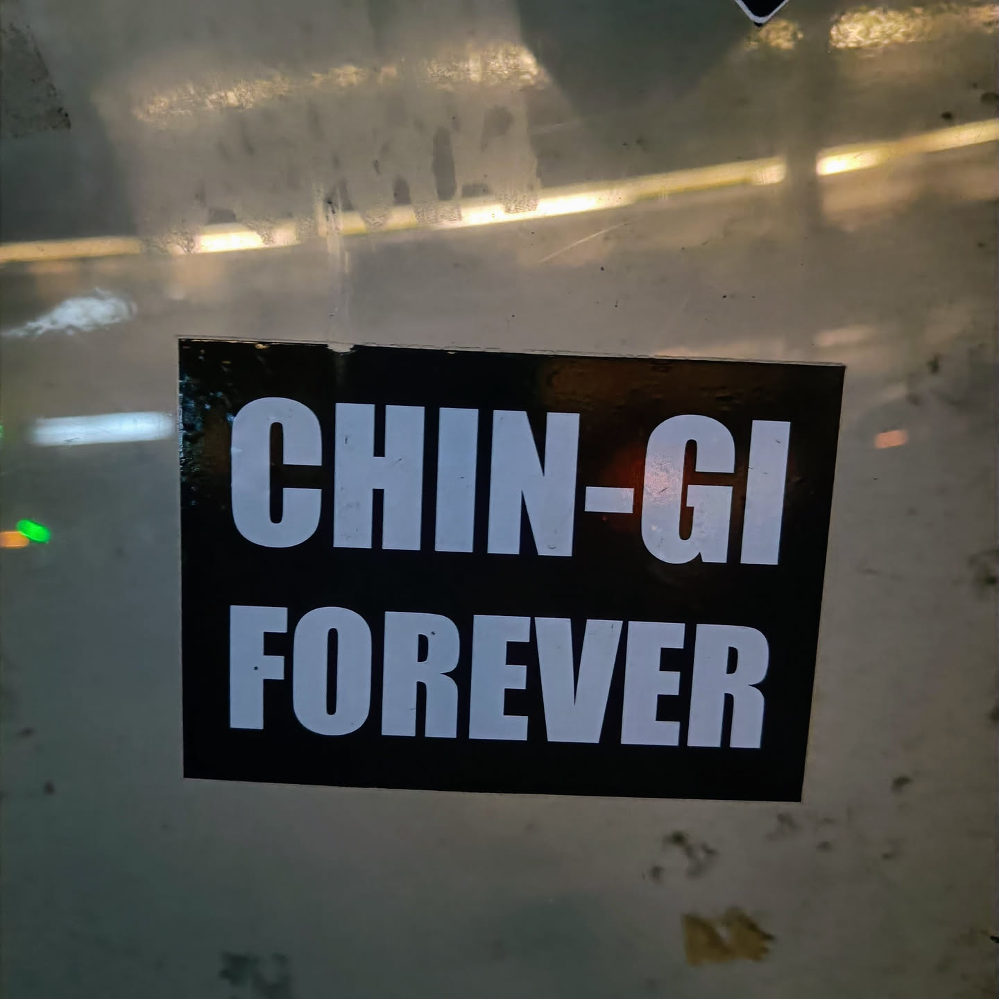 A black and white sticker with the text "CHIN-GI FOREVER" in bold, uppercase, white letters on a black background.