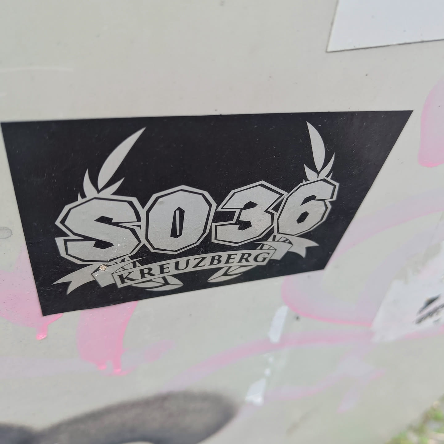 Black and white sticker with the number SO36 and the word Kreuzberg in a stylized design. The number is in bold, uppercase letters, and the word Kreuzberg is written in a banner below.