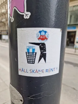 A sticker promoting cleanliness in Skåne, Sweden.  It features a bird-like figure throwing trash into a bin, with the logo of the Helsingborgs IF football club.
