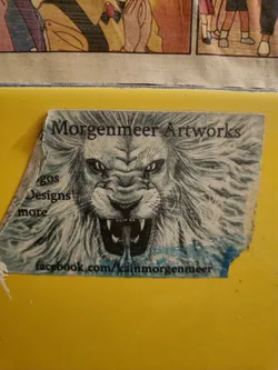 A sticker featuring a detailed pencil sketch of a lion's face. The background is white with the artist's name and a Facebook link at the bottom.