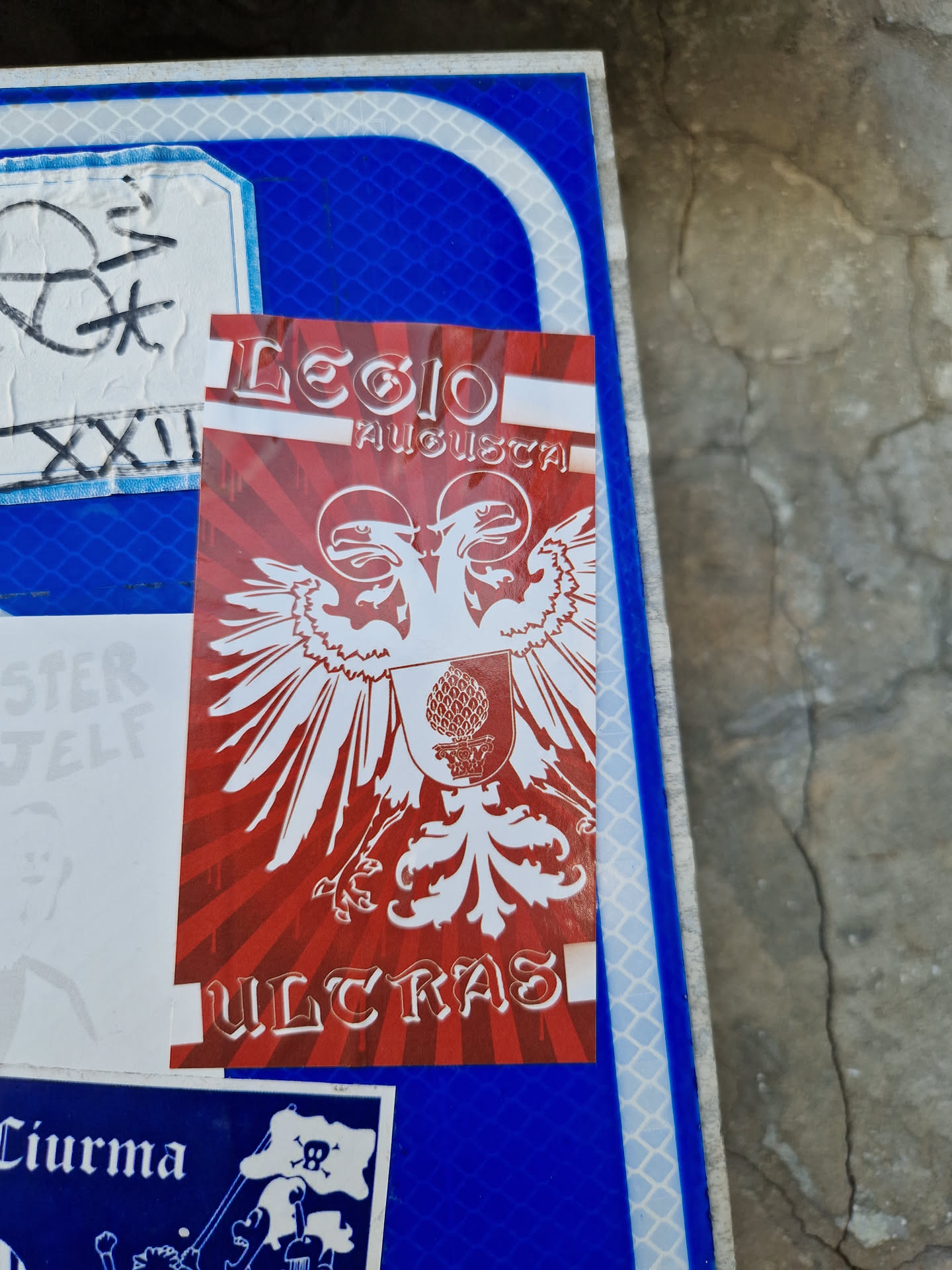A sticker featuring a red and white design with a double-headed eagle and the text 'Legio Augusta' and 'Ultras'.