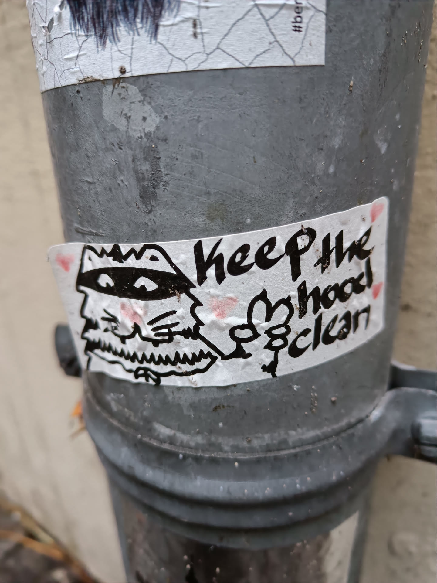 A sticker featuring a cartoon illustration of a creature with a crown and a mustache, along with the text 'Keep the hood clean'.
