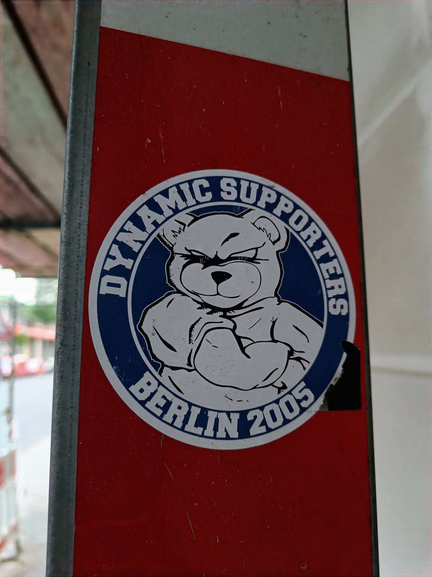A round sticker featuring a teddy bear with its arms crossed. The text on the sticker reads 'Dynamic Supporters Berlin 2005'.