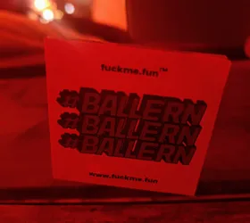 Red square sticker with the text #BALLERN repeated three times and the website www.fuckme.fun at the bottom. The top right corner shows the website's name, fuckme.fun™