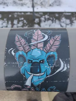 Sticker of a cool koala smoking a joint with three pink feathers on its head. The style is cartoonish and colorful, with a dark background.