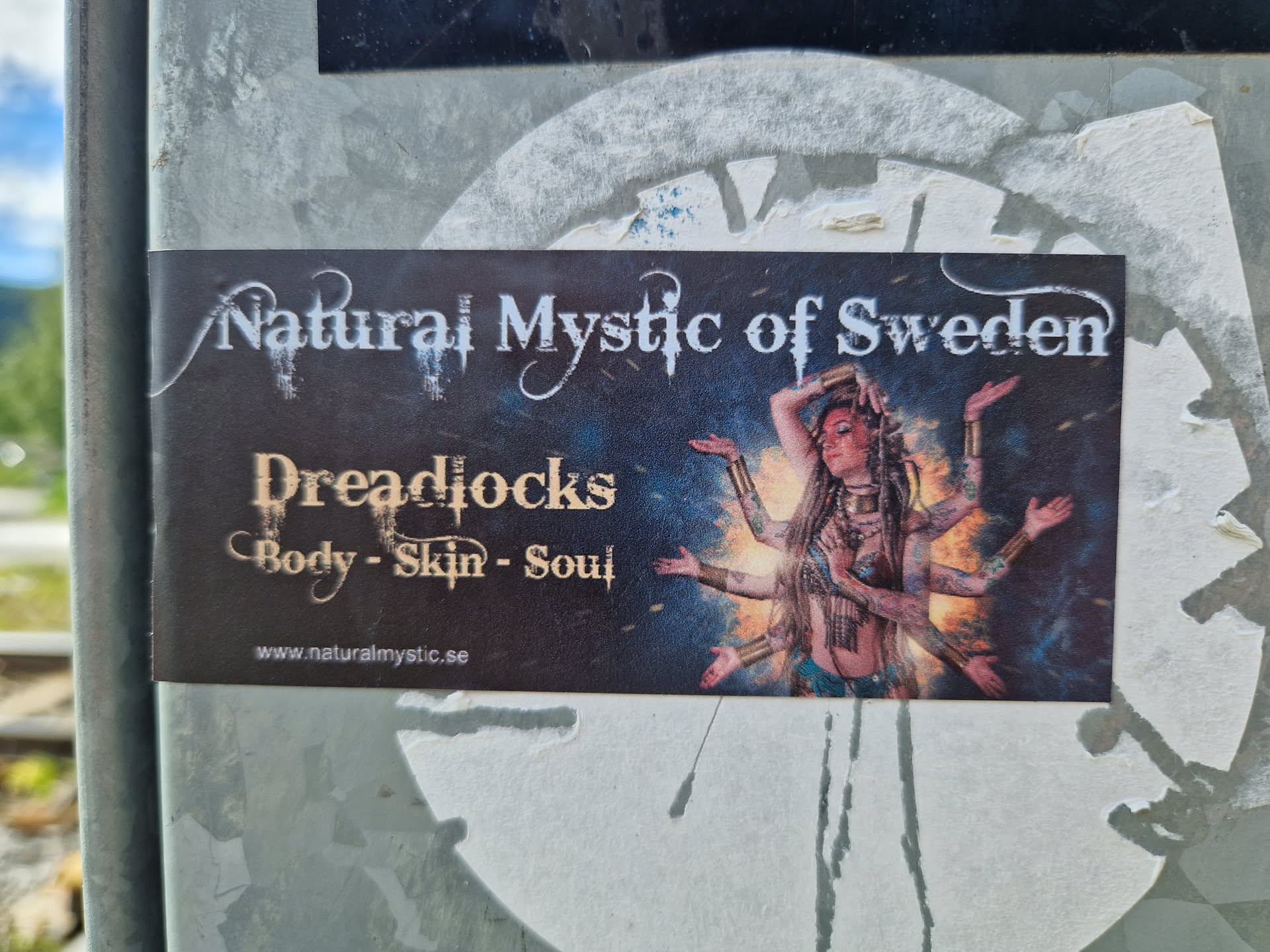 Sticker featuring a woman with dreadlocks and multiple arms, in a cosmic setting. The text on the sticker reads "Natural Mystic of Sweden" and "Dreadlocks Body - Skin - Soul".  A website address is also included.