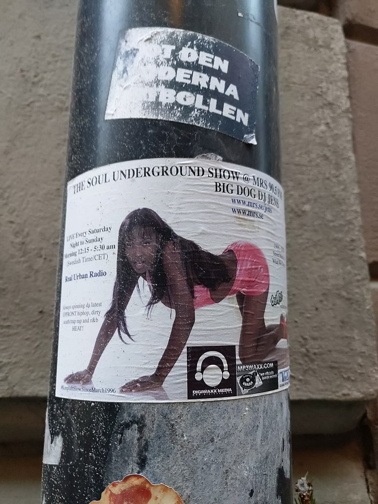 A sticker featuring a flyer for "The Soul Underground Show" on MRS 94.5 FM, hosted by Big Dog DJ Jens. The flyer also mentions Real Urban Radio and has a website address and social media links.  The image includes a woman in a pink outfit in a crawling position.