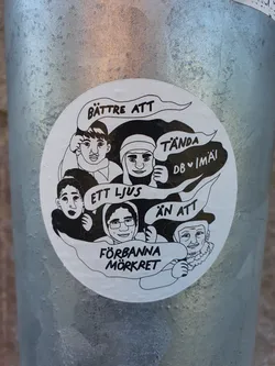 A sticker with a illustration of four people, with text in Swedish. The text translates to:
"Better to light a candle than to curse the darkness"