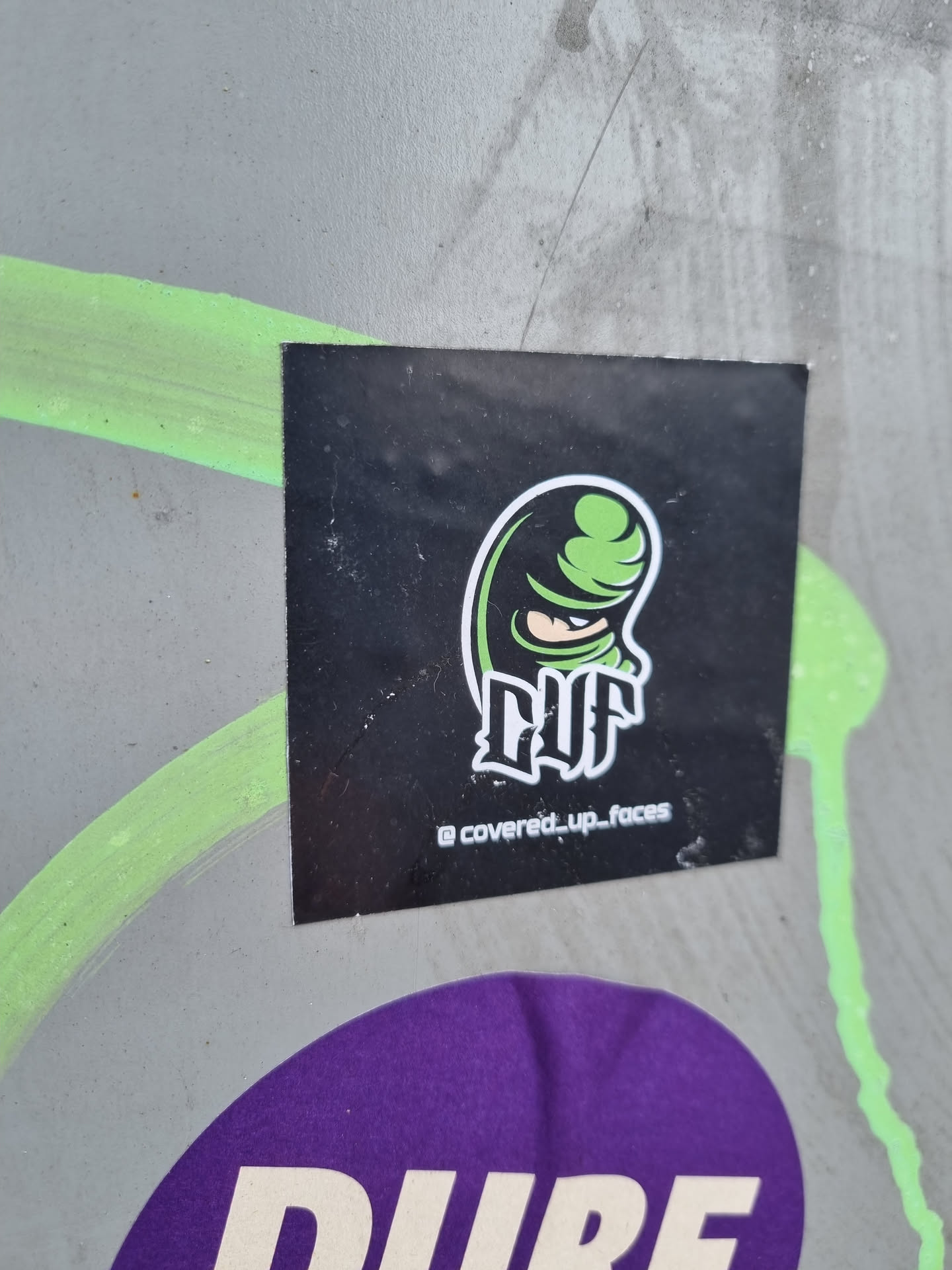 Black and green sticker featuring a stylized masked figure and the logo "CUF". The Instagram handle @covered_up_faces is visible at the bottom. 
