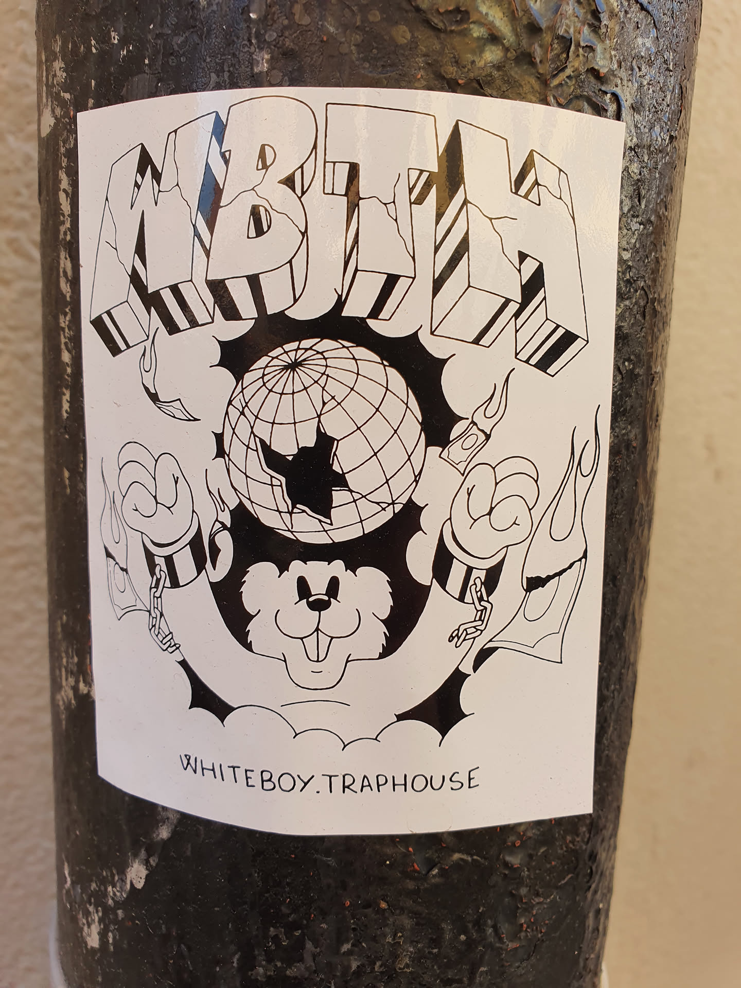 Black and white illustration sticker featuring the text MBTH, a globe with cracks, and a bear-like figure in chains. The text 'WHITEBOY.TRAPHOUSE' is visible at the bottom.