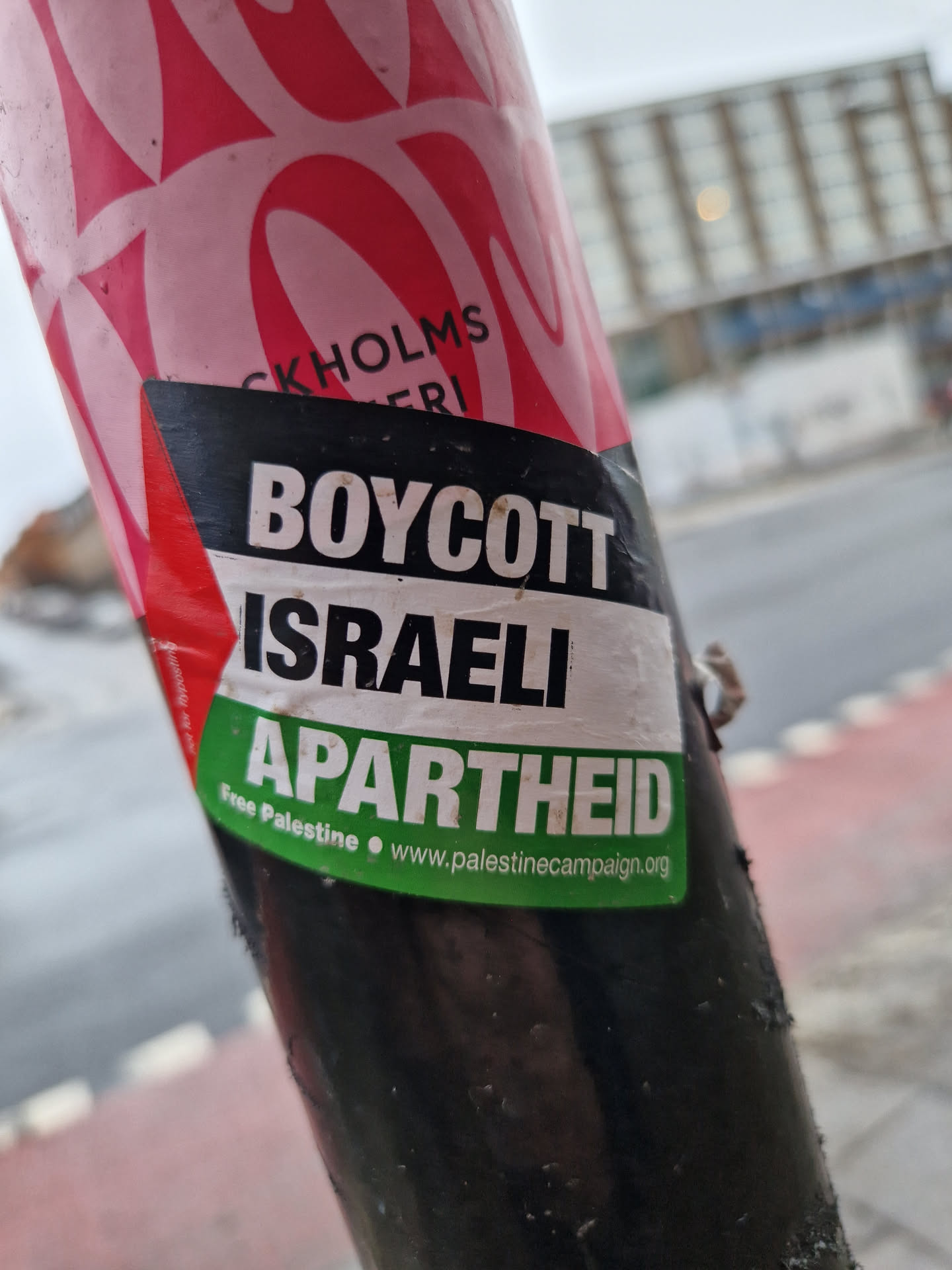 A sticker expressing opposition to Israeli policies. It features the text "Boycott Israeli Apartheid" and a website address.