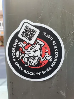 Round sticker featuring a cartoon illustration of a bottle character with the text 'America's Only Rock 'n' Roll Magazine is Back'. It also includes a QR code.